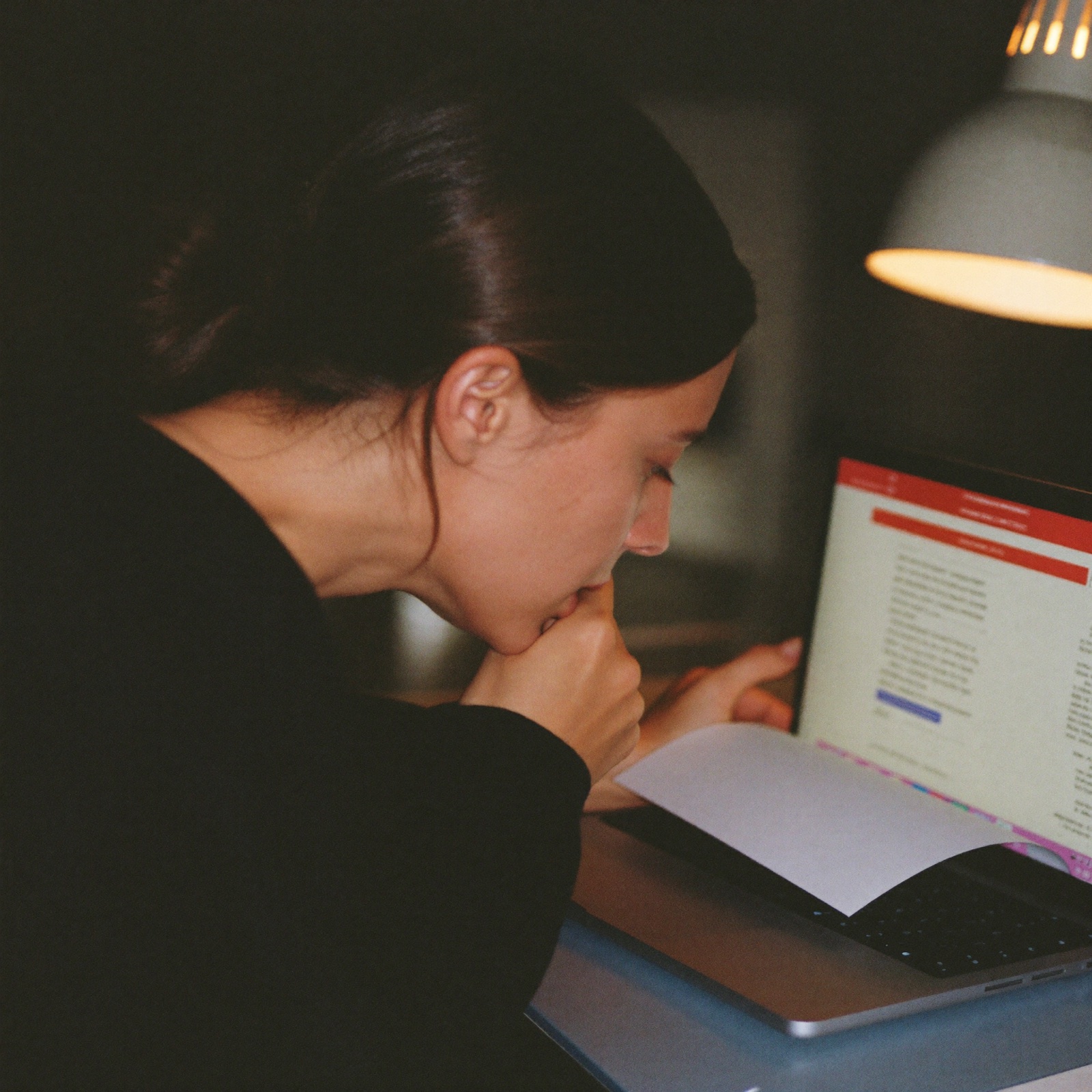 A woman re-reading a sent email again, worried