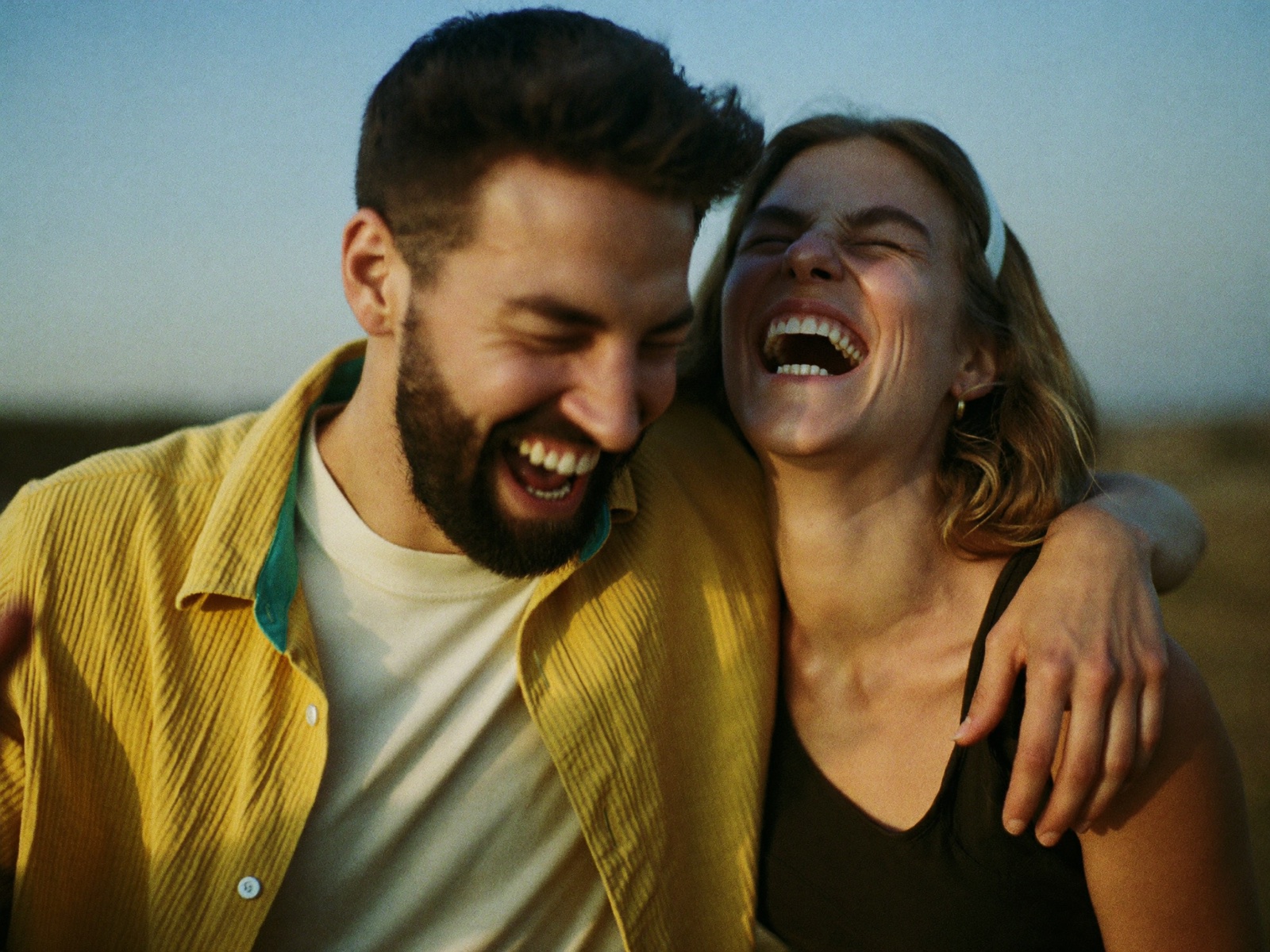 Two friends laughing together outside