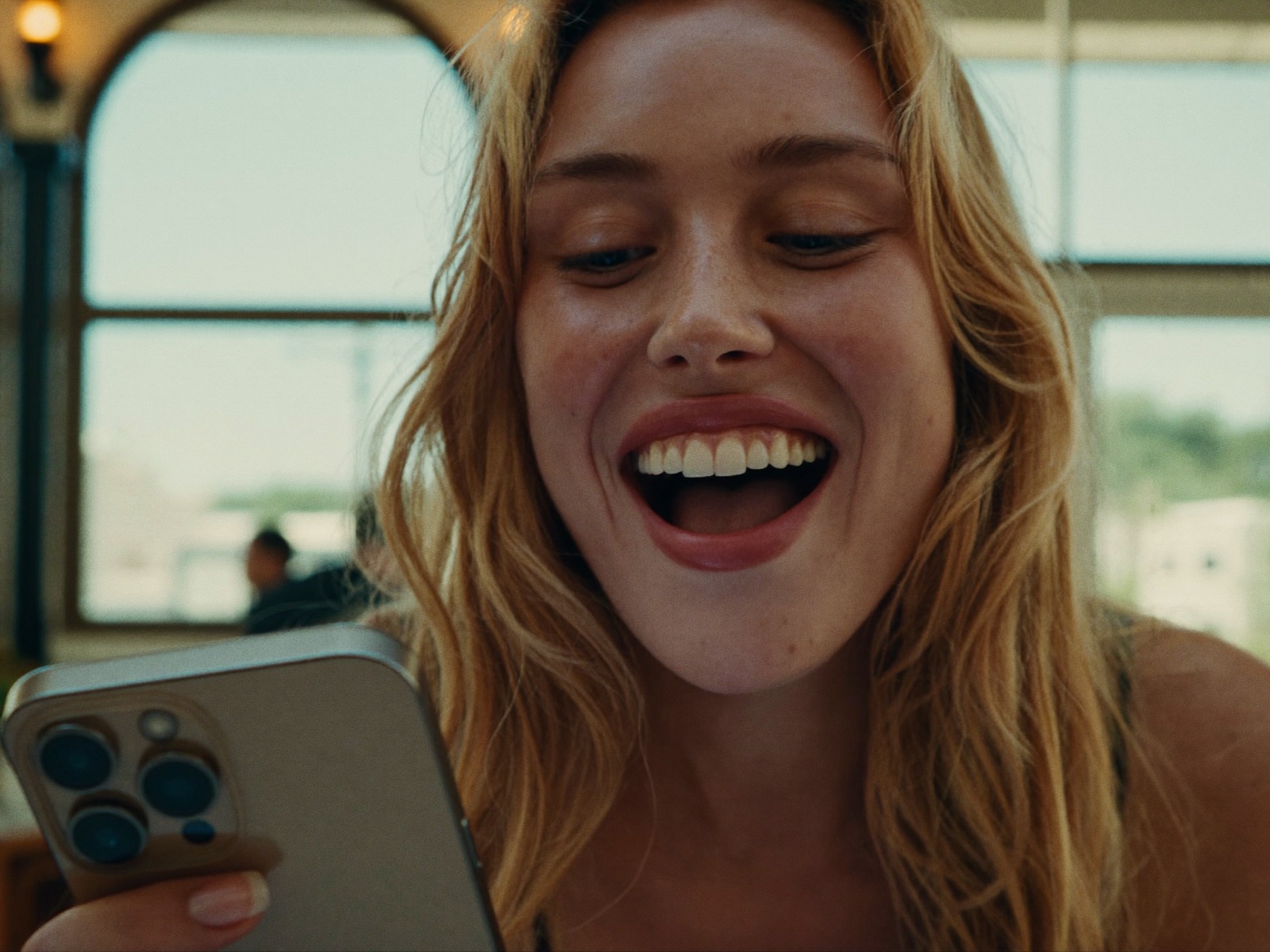 A woman smiling at her progress on her phone