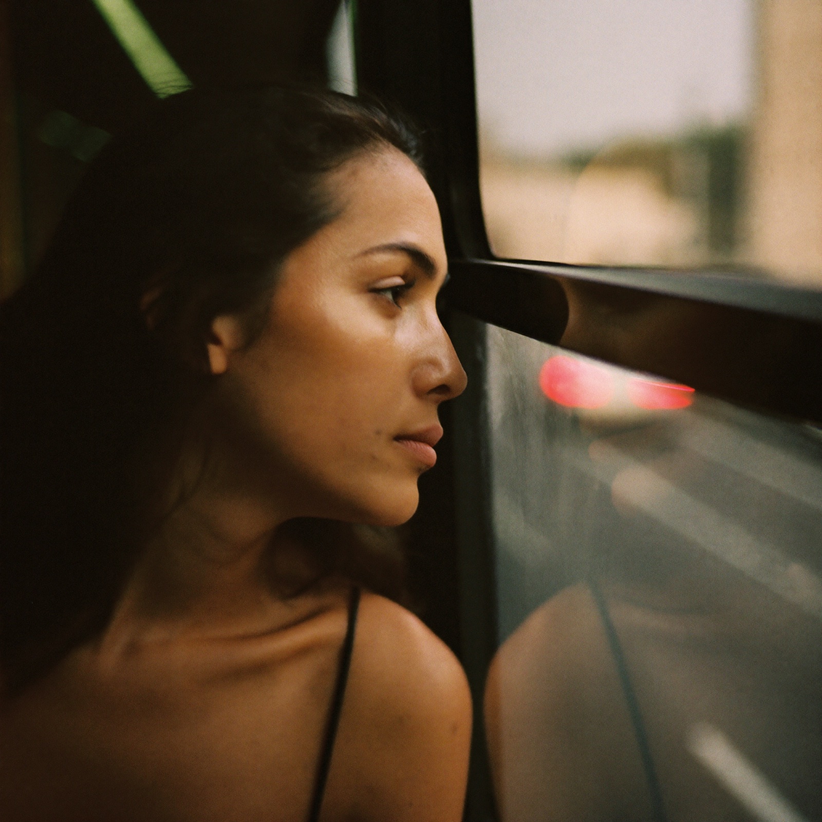 A woman on the bus, lost in the same circling thought
