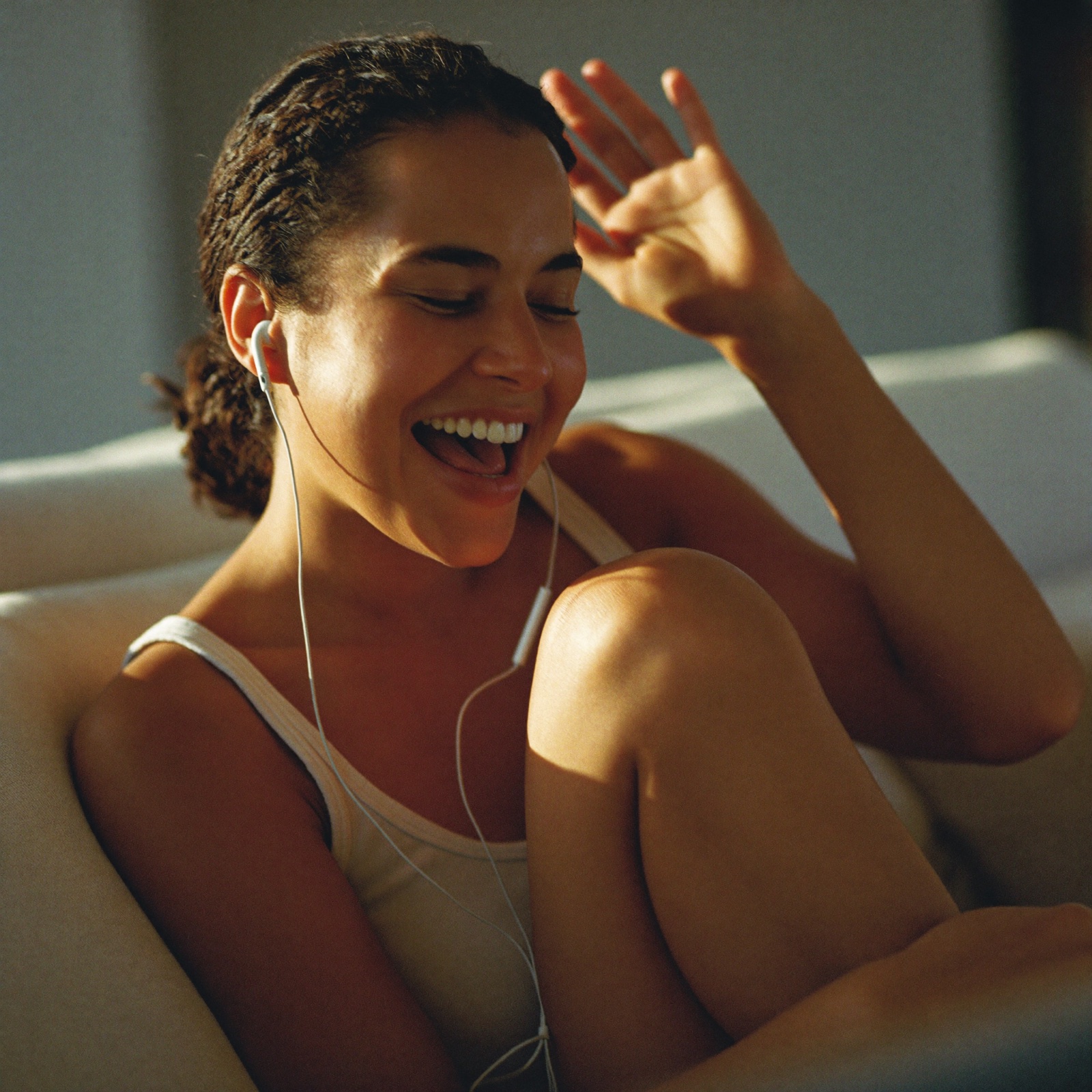 A woman relaxed on the couch, talking with Steady